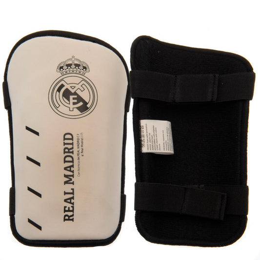 White slip in shin guards featuring the Real Madrid crest and text in black