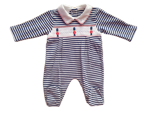 A blue and white striped baby one-piece with smocked panel and little soldier motifs.