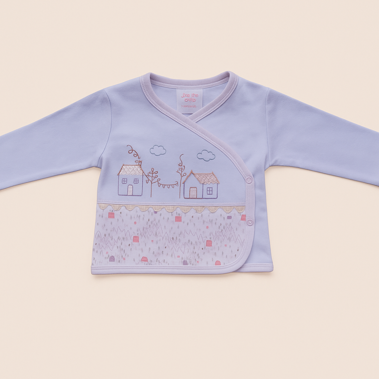 Pink and white Baby jacket with house and cloud design on a beige background