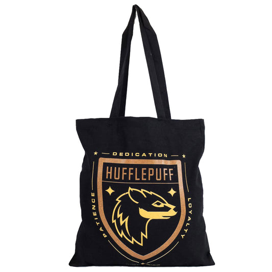 Black canvas tote bag featuring a large gold printed Hufflepuff crest to one side