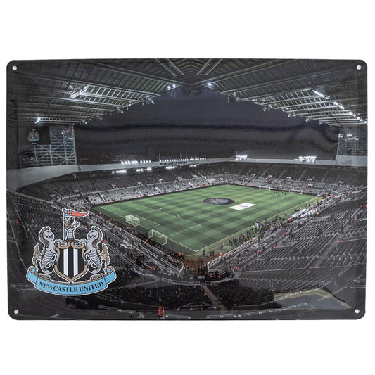 Large metal St James' Park photo sign featuring a night shot of the pitch