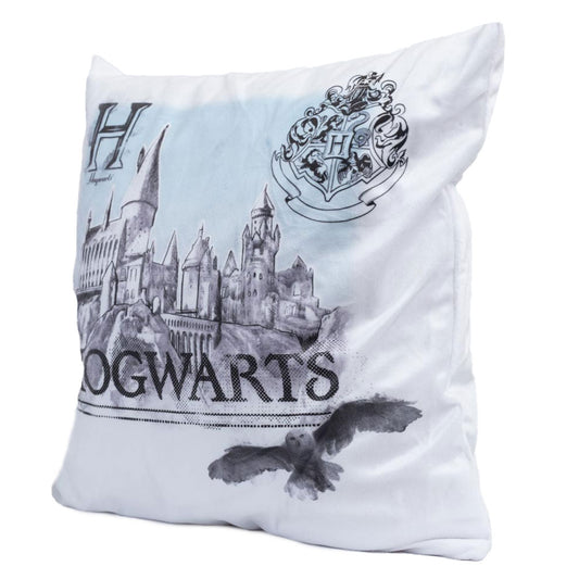 White cushion with an image of Hogwarts and Hedwig flying by