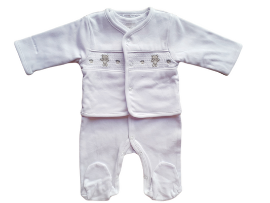 A white baby babygrow and smocked jacket set with a bear motif and paw print detail.