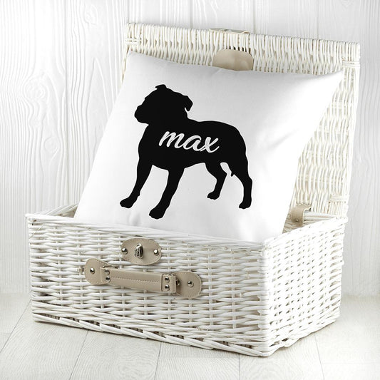 White cushion with black silhouette of a staffordshire bull terrier personalised with name photographed inside a white wicker basket By Sweetlea Gifts