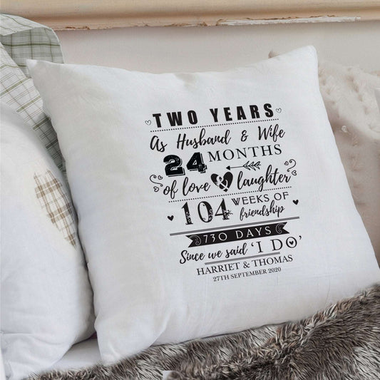White Cotton 2nd Anniversary Cushion with details of 24 moths together in black text personalised with names and date. By Sweetlea Gifts