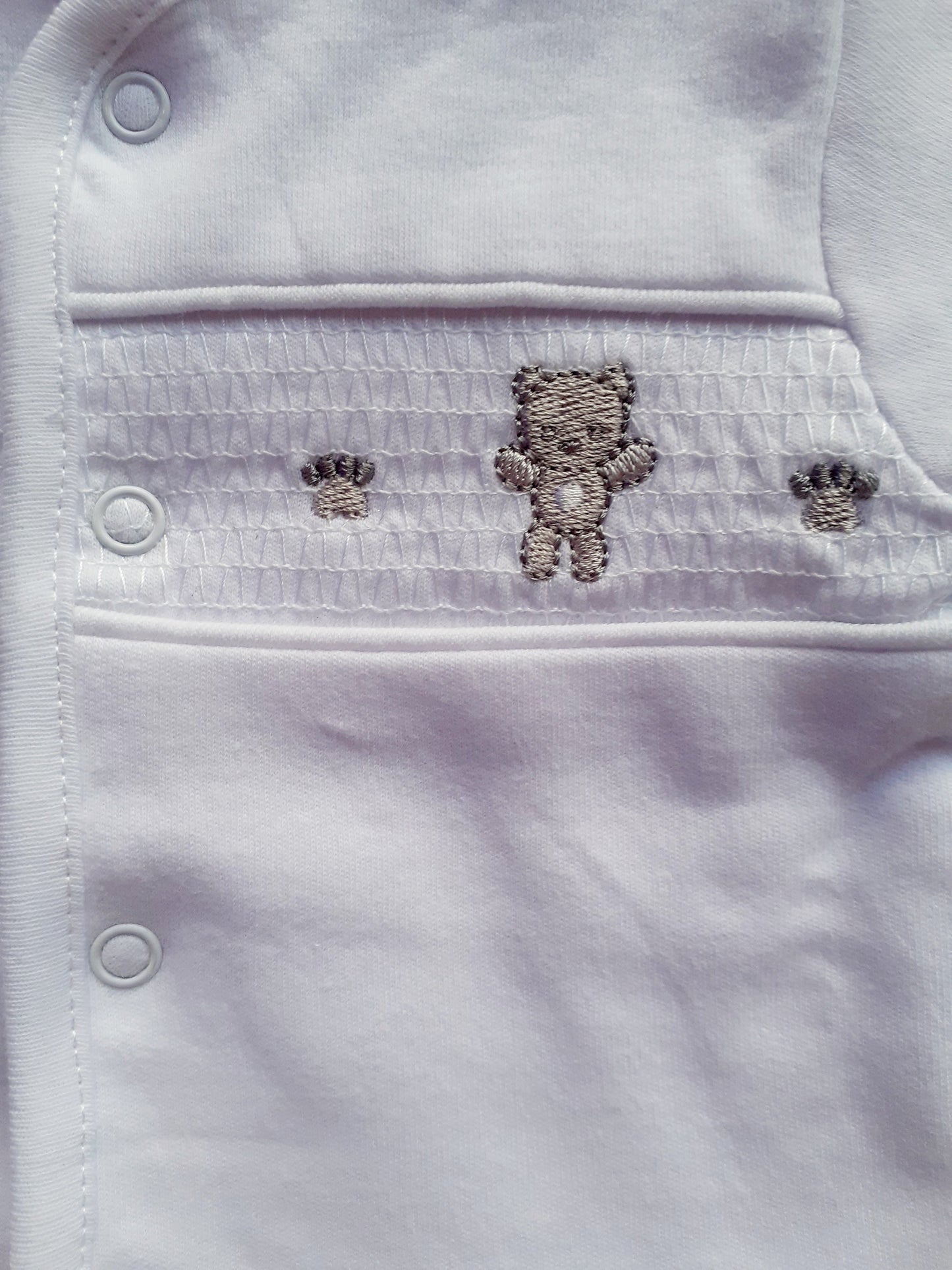 Smocked Bear and paw print motif