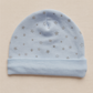 Blue baby hat with star patterns on a beige background