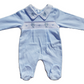 A blue smocked babygrow with a bear and paw pattern, featuring a snap closure at the bottom.