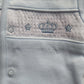 Blue smocked baby jacket with Crown design