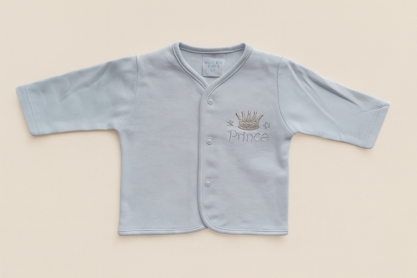 Light blue baby cardigan with 'Prince' and crown embroidery on a beige background
