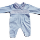 A blue smocked babygrow with star motifs and a snap closure at the top.