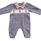 A blue and white striped baby one-piece with smocked panel and little soldier motifs.