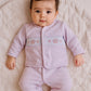 Baby girl in smocked crown and hearts Babygrow outfit