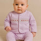 Baby girl in pink 2 piece smocked baby grow set