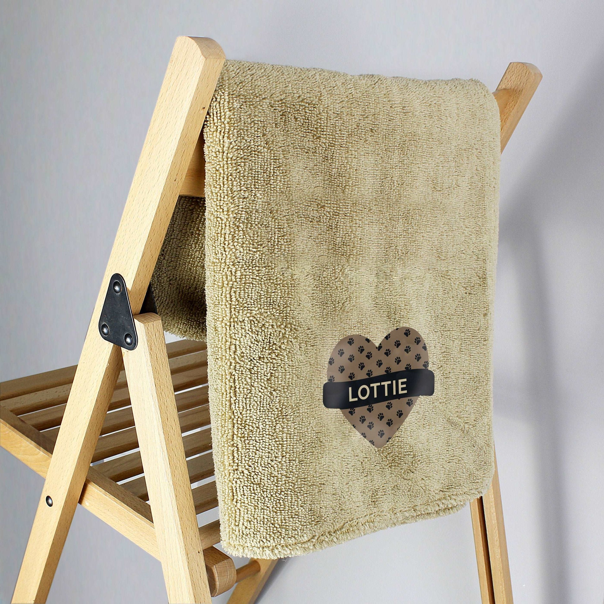 Personalised Heart and paw print Microfiber dog towel displayed on a wooden chair By Sweetlea Gifts