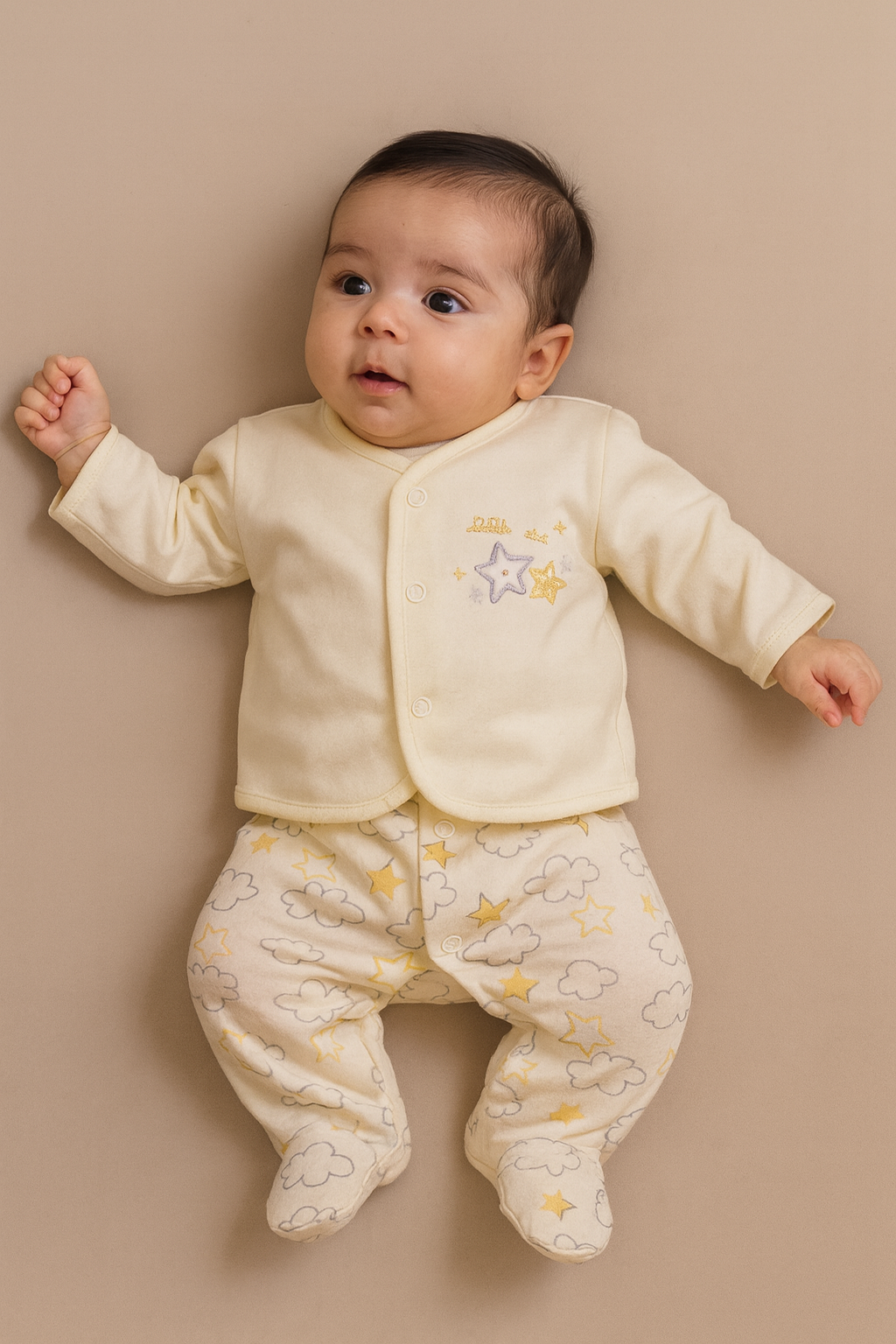 Cute baby in neutral yellow Babygrow and jacket set