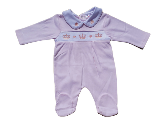 A pink smocked babygrow with a pink crown and hearts motif, featuring a snap-button closure.