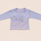 Pink and white Baby jacket with house and cloud design on a beige background