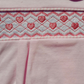 Close-up of a pink fabric with pink heart pattern