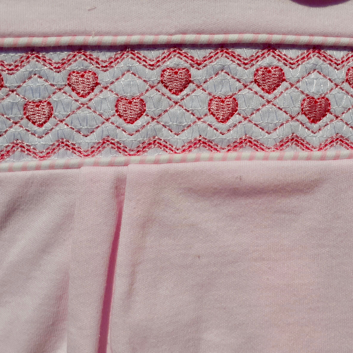 Close-up of a pink fabric with pink heart pattern