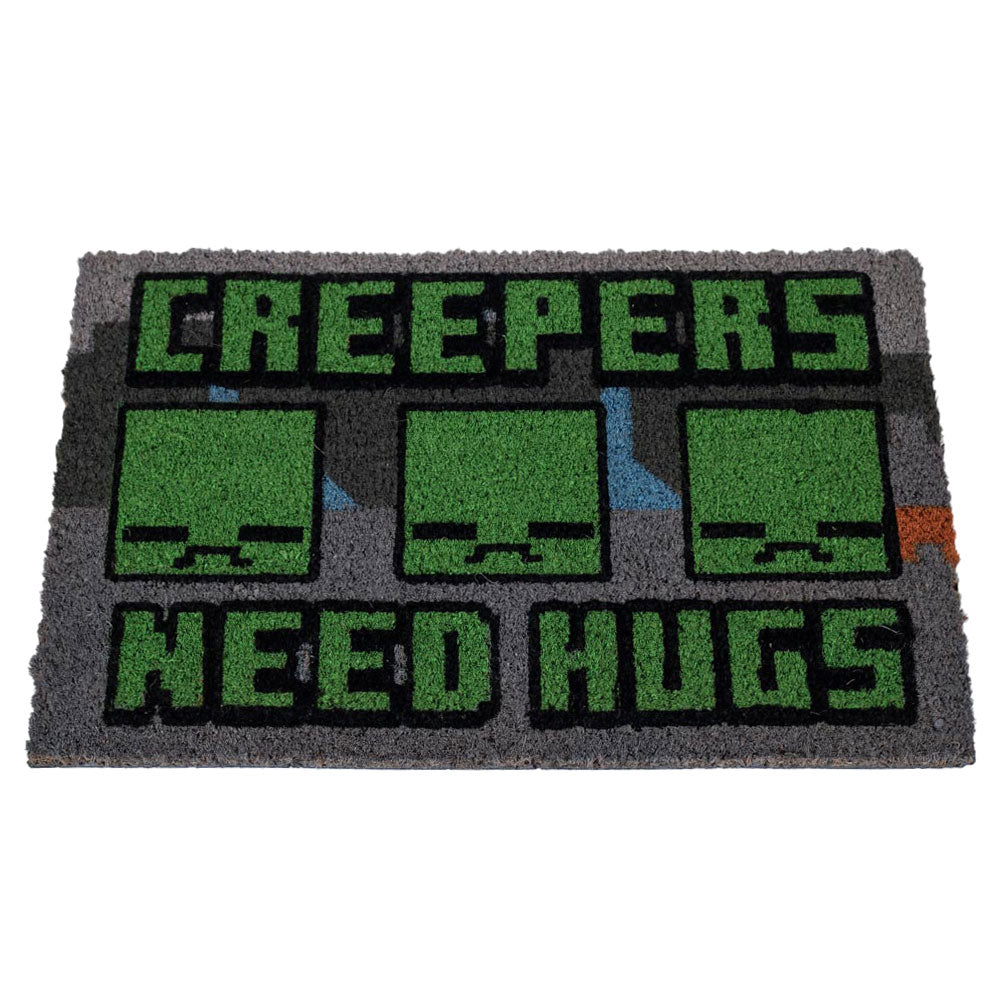 Grey coir doormat featuring the pixelated Creeper faces and the playful warning "Creepers Need Hugs,"