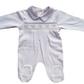White smocked babygrow with a bear face design on the chest.