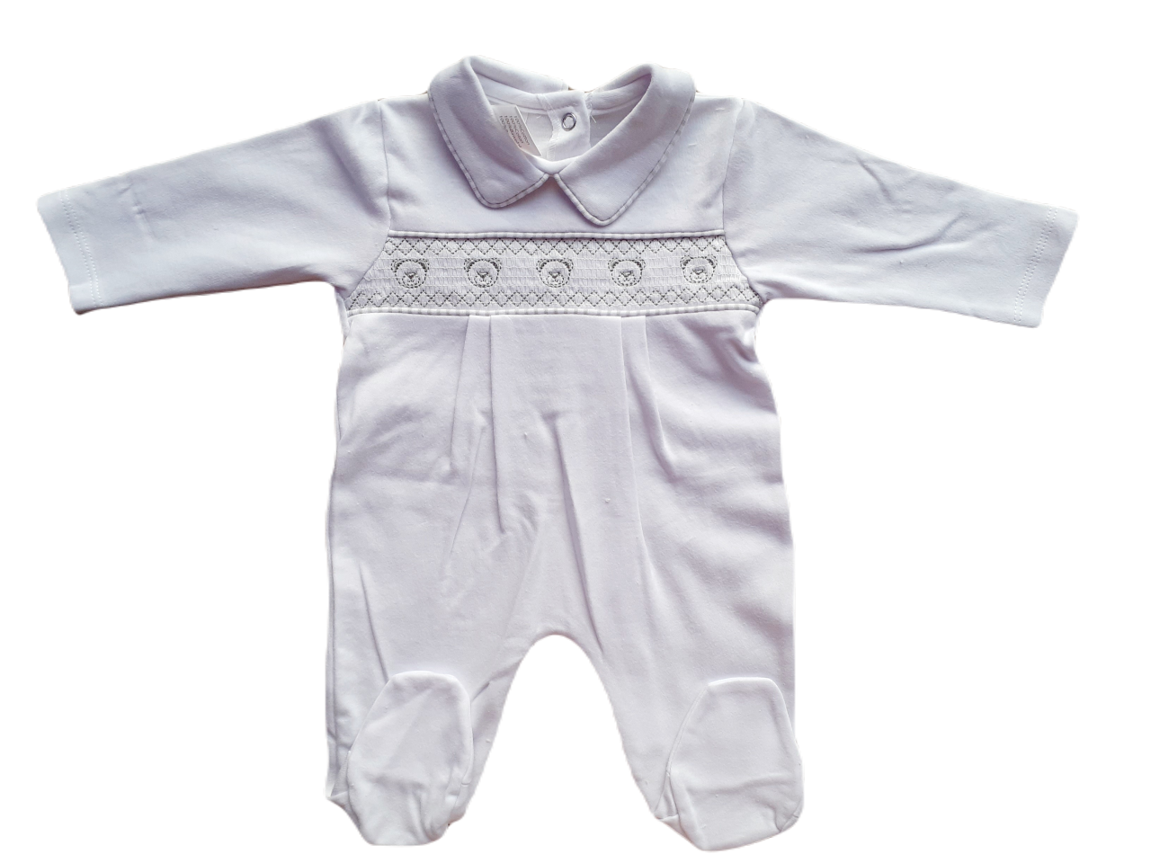 White smocked babygrow with a bear face design on the chest.