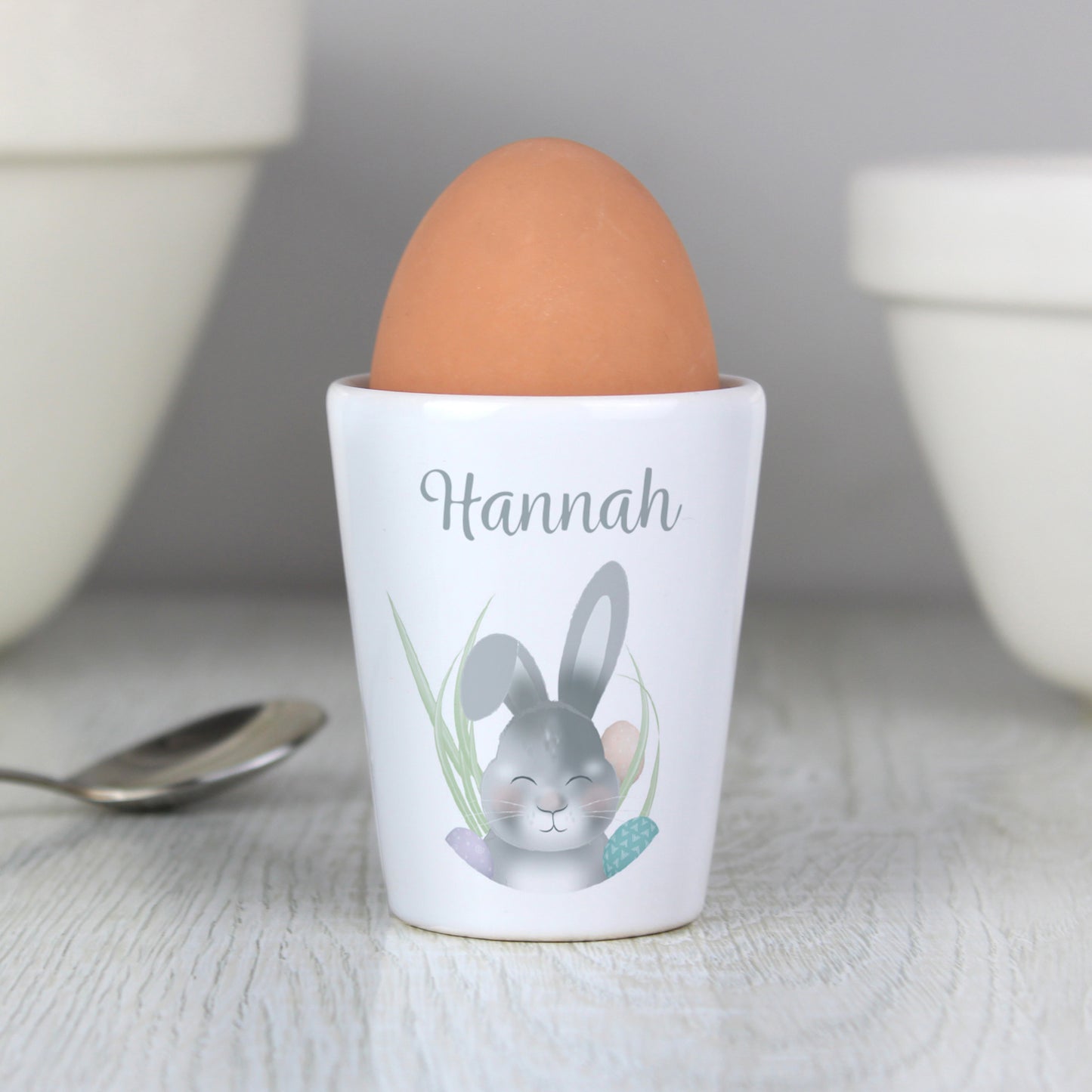 white ceramic egg cup with bunny image and personalised with a name