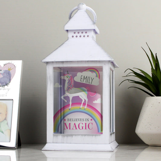 white lantern with colourful unicorn design printed on front picutred with a white plant pot with succulent in and silver photo frame By Sweetlea Gifts