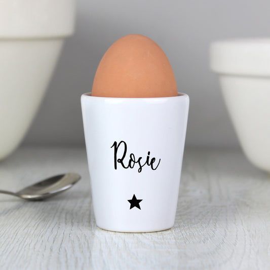White ceramic egg cup personalised with name and star in black